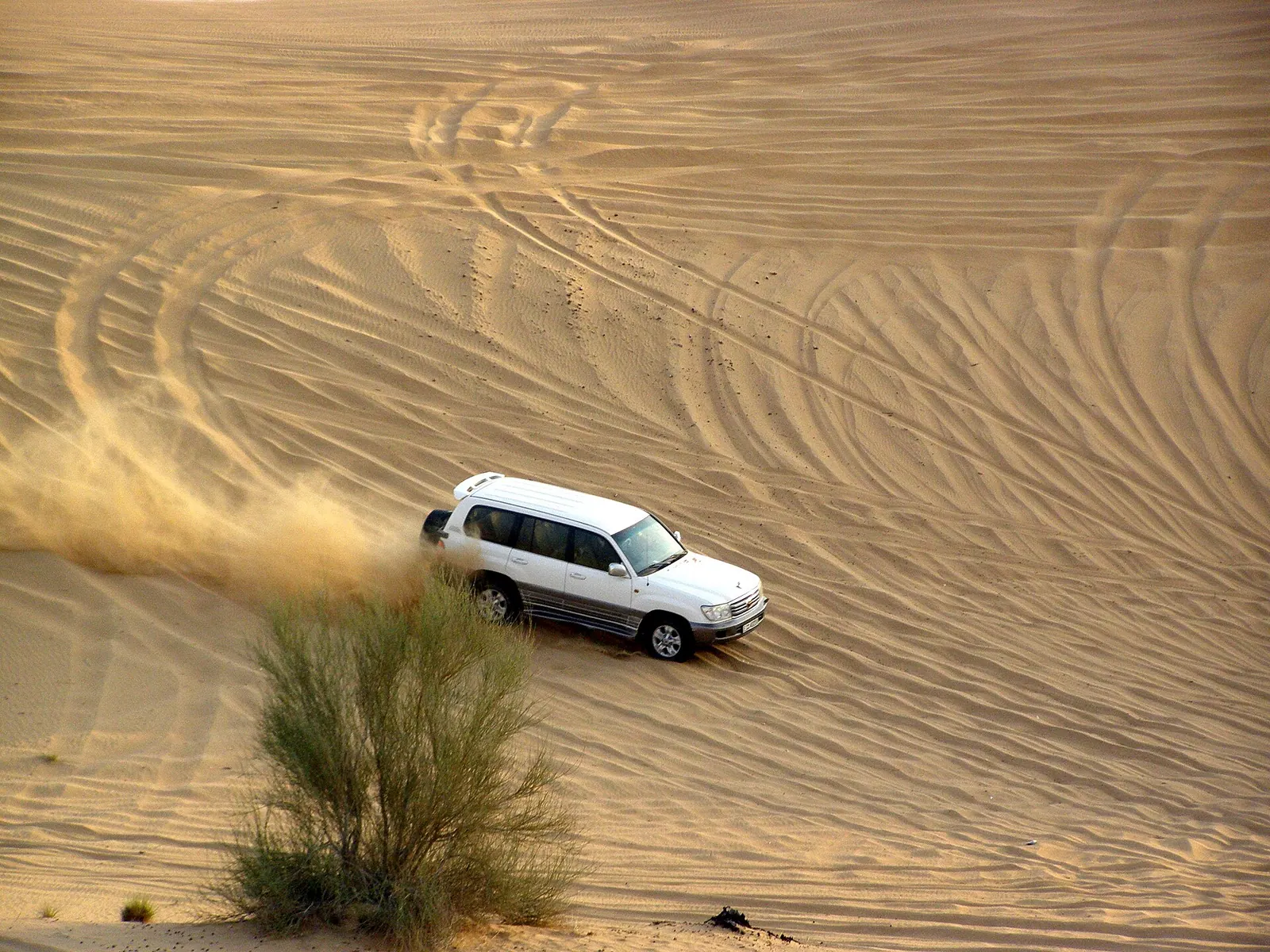 4x4 vehicle mid dune bash in the red desert dunes outside Dubai