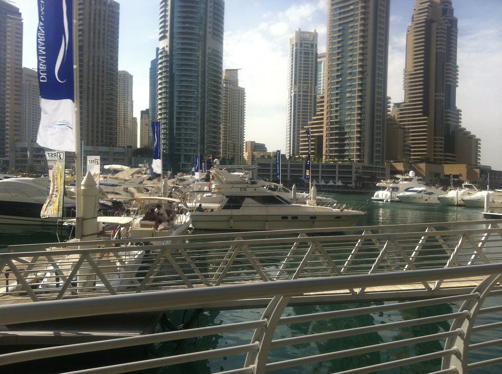 Luxury yacht cruising Dubai Marina at sunset